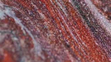 Parıltılı boya döküldü. Mürekkep damlası. Odaklanmamış kahverengi altın rengi ışıl ışıl parçacıklar mermer dokusu sıvı cila akışı soyut sanat arka planı.