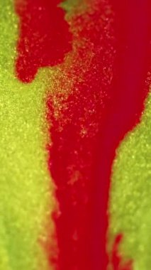 Islak sim akışı. Mürekkep damlası. Bulanık kırmızı, parlak, sarı renk, metalik desen, sıvı, dalga, hareket, soyut sanat arka planı..