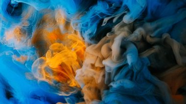 Boya suyu sıçraması. Buhar bulutu. Odaklanamayan mavi sarı renkli ışıldayan parçacıklar patlama dumanı soyut sanat arkaplanı.