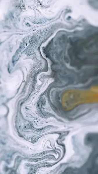 stock image Ink fluid mix. Marble texture. Defocused white gray color golden sand particles pigment powder acrylic swirl paint emulsion fluid spill abstract art background.