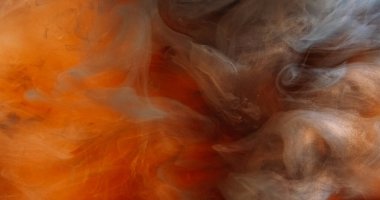 Parlak toz. Duman bulutu. Işıl ışıl koyu turuncu mürekkep. Hipnotize edici soyut sanat arka planı sihirli atmosferik titreşen sis.