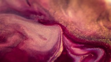 Parıltılı boya akışı. Parlak mürekkep. Odaklanmamış morumsu pembe altın sarısı beyaz renkli parlak toz tanecikleri su pigmenti emülsiyon sızıntısı hareketli soyut sanat arkaplanı.