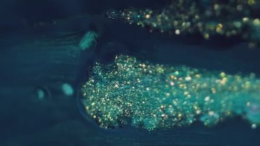 Parıldayan sıvı. Bokeh ışığı. Odaklanmamış mavi altın rengi parıldayan parçacıklar doku boya dalgası soyut sanat arkaplanı.