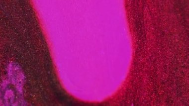 Işıldayan parlatıcı. Parlak sıvı damlası. Bulanık neon pembe renk parlak parçacıklar boya damla damla cazibe soyut sanat arka planı.