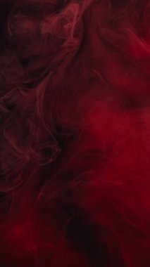 Karanlık sis akışı. Mürekkep suyu karışımı. Odaklanmamış kırmızı siyah renk toz parçacıkları yüzen buhar bulutu dokusu girdap soyut sanat arkaplanı.