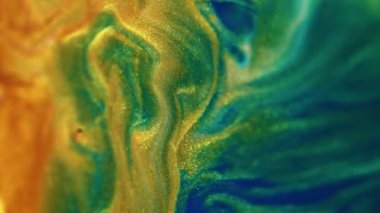 Köpüklü sıvı dalgası. Boya dökülmüş. Islak pul dokusu. Odaklanmamış altın sarısı mavi çivit rengi parlak parçacıklar karışık hareket soyut sanat arka planı.