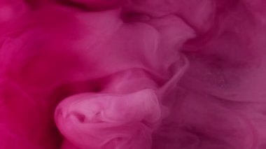 Mürekkep damlası. Buhar bulutu. Odaklanmamış morumsu pembe renkte parıldayan simler patlama dumanı soyut sanat arkaplanı..