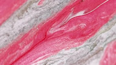 Soyut arkaplan. Islak boya. Parıltı damlıyor. Parlak dekoratif pembe bordo beyaz yumuşak sıvı akışı büyüleyici fantezi makro moda sanatında.