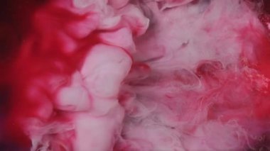Boya su sıçratır. Duman dalgası. Odaklanmamış kırmızı beyaz renkli simli toz dokusu patlama buharı akışı siyah soyut sanat arka planında hareketi ortaya çıkarıyor.