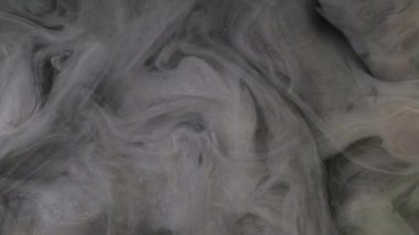 Parlak duman dokusu. Duman külü. Odaklanmamış gri renkli, ışıl ışıl parçacıklar yüzen boya suyu sıçrama hareketi karanlık soyut sanat arkaplanı.