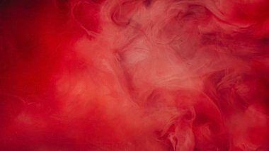 Mürekkep damlası. Duman bulutu. Odaklanmamış kırmızı pembe renk, su altında parıldayan parıltılı parıltı, patlamalar, soyut sanat arkaplanı gibi hayaller..
