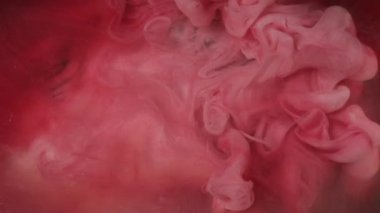Mürekkep damlası. Duman bulutu. Odaklanmamış kırmızı pembe renkte parıldayan parıldayan parıltı su altı patlaması kabarcığı soyut sanat arkaplanı gibi hareket ettiğini gösteriyor..