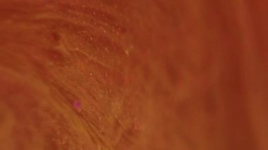 Kızgın yağ. Mürekkep jeli. Odaklanmamış turuncu renkli parlak parlak sıvı kıvrımlı kıvrımlı kıvrımlı yumuşak eğimli merhem bokeh ışıkları soyut arkaplan.