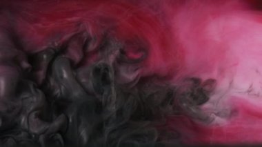 Parlak mürekkep suyu. Duman bulutu. Odaklanmamış pembe renkli parlak parçacıklar patlama dokusu buhar akışı hareket soyut sanat arkaplanı ortaya çıkarıyor.