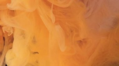 Renk kokusu yayılıyor. Su damlasını boya. Bulanık sarı toz parçacıkları doku buharı yüzen hareket soyut sanat arkaplanı.