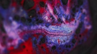 Köpüklü sıvı. Boya lekeleri. Odaklanmamış siyah mavi pembe renkli simli sıvı kirli damlalarla akıyor yağ karışımı hareketli soyut sanat arkaplanı.