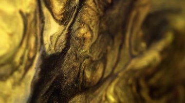 Mürekkep dalgası. Parıldayan sıvı akışı. Odaklanmamış siyah sarı renk karışımı katmanlar parıldayan pullu parçacıklar desen boya emülsiyon hareket soyut sanat arka planı.