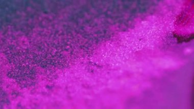 Mürekkep damlası. Neon arka plan. Bulanık floresan pembe mor siyah siyah parlak parlak parçacıklar sıvı boya akışı soyut sanat dokusu.