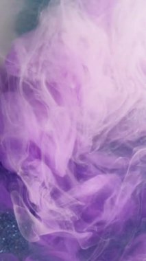 Dikey video. Renkli duman karışımı. Mürekkep akışı. Sıvı galaksi. Mor beyaz bej rengi ipek sisli, bulut sıvısı, koyu mavi parıltılı parçacıklar, sanat soyut arka plan..