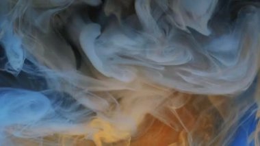 Mürekkep damlası. Duman bulutu. Odaklanmamış mavi turuncu renkli sim parçacıkları. Doku buharı. Girdap açıcı hareketi..