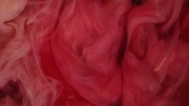 Parıldayan sis. Boya suyu sıçraması. Odaklanmamış pembe renkli parlak parçacık dokusu su altında buhar bulutu açıcı hareket soyut sanat arkaplanı.