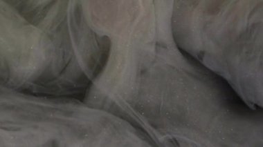 Buhar tozu. Duman külü. Odaklanmamış gri renkli, ışıl ışıl parçacıklar yüzen boya suyu sıçrama hareketi karanlık soyut sanat arkaplanı.