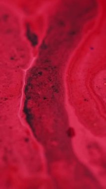Dikey video. Akrilik renk damlası. Boya sıvısı karışımı. Odaklanmamış kırmızı pigment tozu tanecikleri su boyası mürekkep emülsiyonu sıvı akış hareketi soyut sanat arkaplanı.