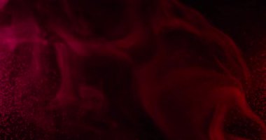 Mistik akış. Duman patlaması. Kırmızı pembe mürekkep resimleri sanatsal emülsiyon yayıyor. Renkli su soyut arkaplan bulanık siyah parıltı.