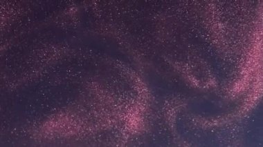 Işıltılı girdap. Boya akışı. Pembe renkli, parlak toz, sisli dalgalar, koyu mavi soyut arka planda hareket yayıyor..