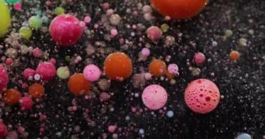 Renkli köpük. Sabun boyası. Işıldayan suyun içinde yüzen yuvarlak köpük baloncukları. Yaratıcı sıvı parçacıkları soyut arkaplan.