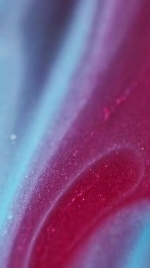 Dikey video. Parıldayan sıvı dökülmüş. Bokeh ışığı. Odaklanamayan kırmızı mavi renk kum dokusu mürekkep dalga hareketi soyut sanat arkaplanı.