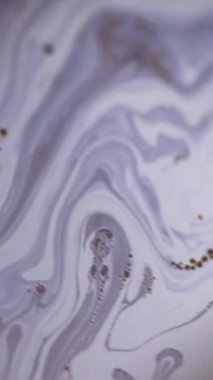 Dikey video. Mürekkep köpüğü. Köpüklü sıvı akışı. Odaklanmamış mavi sarı yağ dokusu koyu soyut sanat arka planında sıvı dalga hareketi.