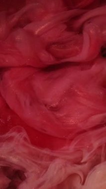 Dikey video. Işıltılı duman girdabı. Suyu boya. Odaklanmamış kırmızı altın rengi parlak parçacık dokusu su altı buhar bulutu açıcı hareket zebra desenli soyut sanat arkaplanı.