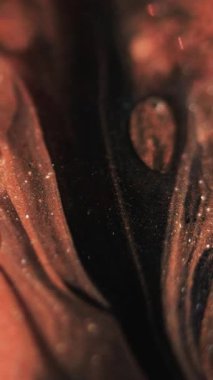 Dikey video. Parıldayan sıvı dökülmüş. Mürekkep damlası. Odaklanmamış mercan siyah renk parıldayan desen jel emülsiyon damla dalga hareketi soyut sanat arka planı.