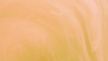 Sis akışı. Dönme dolap. Odaklanamayan parlak şeftali rengi, turuncu boya, mürekkep buharı, soyut sanat arka planında hareket ediyor..