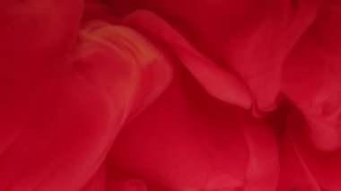 Duman sıçrıyor. Boya bulutu. Kırmızı renkli mürekkep suyu koyu siyah simli parçacıklar üzerine girdap deseni soyut sanat arkaplanı.