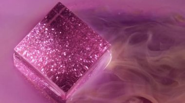 Parlak parlatıcı. Parlak parlak boya. Parlak sarı mor renk akışı duman parlayan küp küp mürekkep dokusu sanat ışığı arka planında yüzüyor.