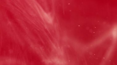Boya sıvısı damlası. Duman bulutu. Odaklanmamış kırmızı renk parıldayan parlak boya soyut sanat arka planında yüzen köpüklü su damlası.