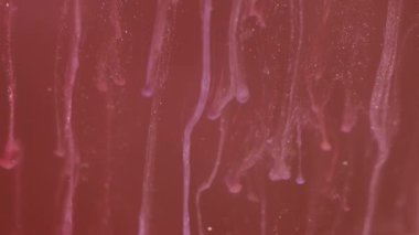 Mürekkep damlası. Bulanık parıltı sıçraması. Odaklanmamış kırmızı renk parlaklığı soyut sanat ışığı arka planında akışkan duman dokusu dalgası.