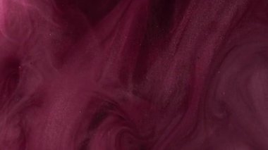 Renkli bir dönüş. Parıldayan sıvı. Açık kırmızı parıldayan desen parlak boya mürekkep dumanı kara soyut sanat arka planında duman buharı.