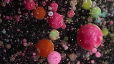 Emülsiyonu bırak. Sabun boyası. Işıldayan suyun içinde yüzen yuvarlak köpük baloncukları. Yaratıcı sıvı parçacıkları soyut arkaplan.