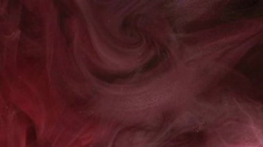 Renkli bir dönüş. Parıldayan sıvı. Açık kırmızı parıldayan desen parlak boya mürekkep dumanı kara soyut sanat arka planında duman buharı.