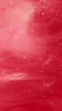 Dikey video. Boya suyu akışı. Renk karışımı. Odaklanmamış kırmızı beyaz parıltılı duman bulutu soyut sanat arka planında yüzen sıvı damlacıklar..