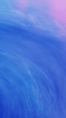 Dikey video. Buhar girdabı. Işıldayan girdap. Odaklanmamış parlak mavi parçacıklar soyut sanat arka planında hareket eden boya mürekkebi dumanı bulutu.