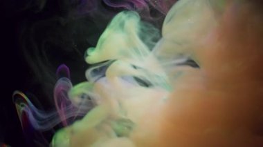 Puslu sanat patlaması. Renkli sis. Siyah, pırıl pırıl arka planda bir bulut girdabı. Gökkuşağı mürekkebi karışımı, parlayan, parlayan, odaklanmış sıvı..