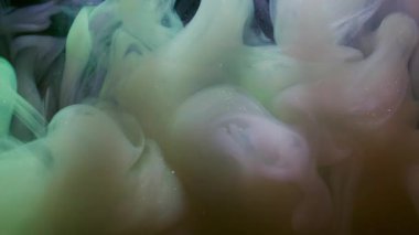 Su altı boyası. Haze girdabı. Soyut sıvıda pembe bej rengi sisli akış mürekkebi. Siyah arkaplanda fantezi bulanık renk damlası karışımı.