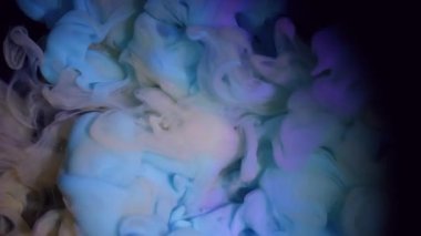 Duman akışı. Buharı boya. Mavi sarı dumanlı patlama. Sanat menekşesi sıvısında karıştırıcı renk. Siyah soyut odaklanmış arkaplan.