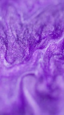 Dikey video. Işıldayan sıvı dökülmesi. Islak sim akışı. Odaklanmamış mor renkli parlak parçacıklar akrilik mürekkep dalgası dokusu soyut sanat arkaplanı ve bokeh ışık.