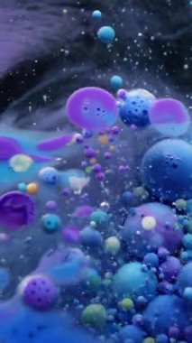 Dikey video. Renkli akış. Kabarcık boyası. Su yağı karışımı pigment damlası patlıyor. Mavi mor parçacıkları dolduran dalga koyu soyut arkaplan.