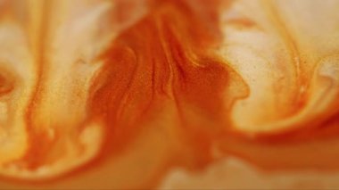 Enamel sıvısı. Pırıl pırıl. Soyut akrilik zemin üzerine dökülen su lekelerinde çözünmüş sarı turuncu renkli boya..